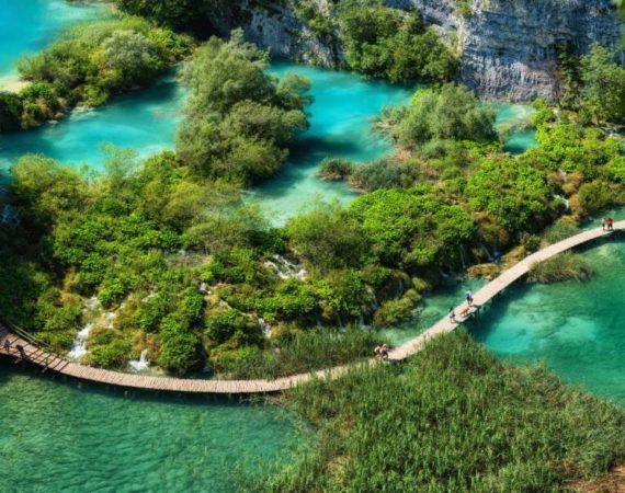 Plitvice lakes in Croatia. National Park in summer. Waterfalls and lakes among the forest. Footpath for hiking. Croatian travel image.